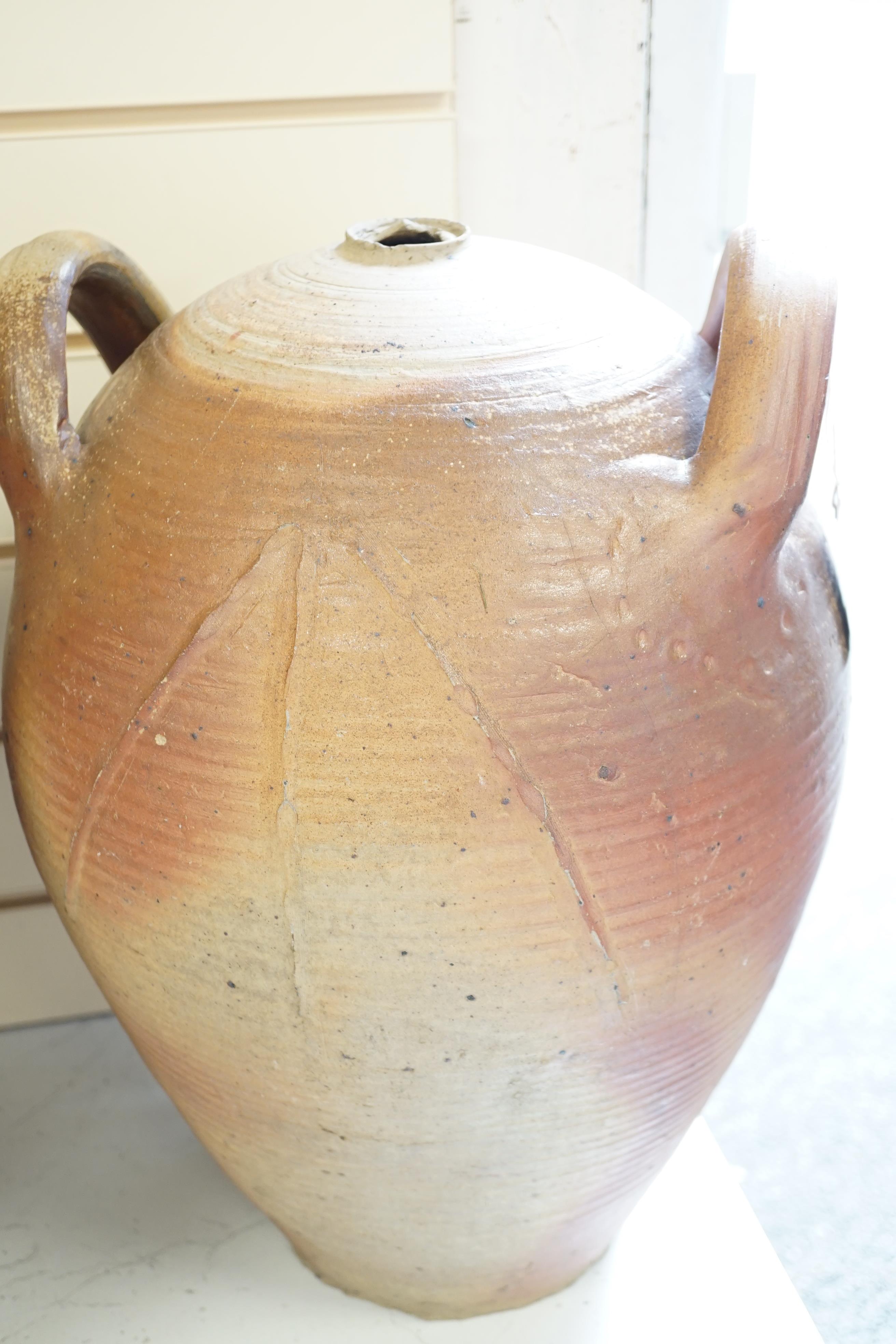 Two terracotta oil jars, tallest 49cm